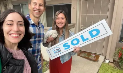 Brenda Robles and friends holding a Steele San Diego Homes SOLD sign outside their new home